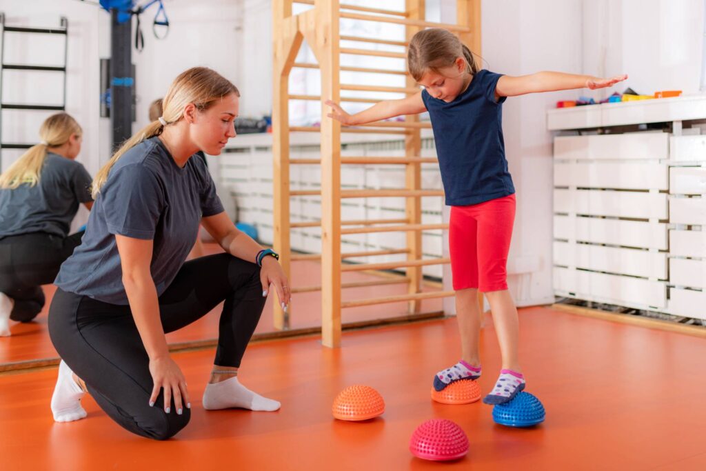 Child training for balance improvement and flat feet correction, walking over spiked half-balls