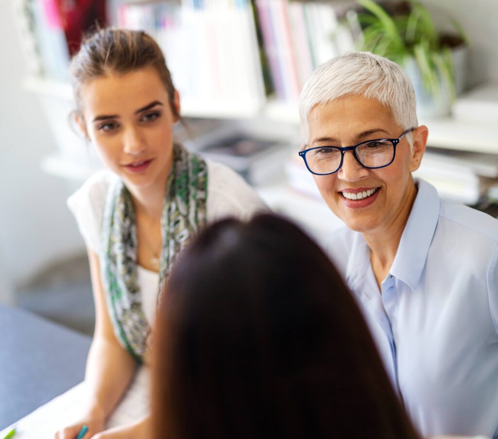 Portrait of happy business women working as a team at the office on meeting